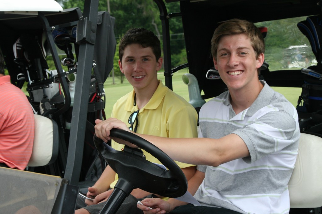 boys in golf cart